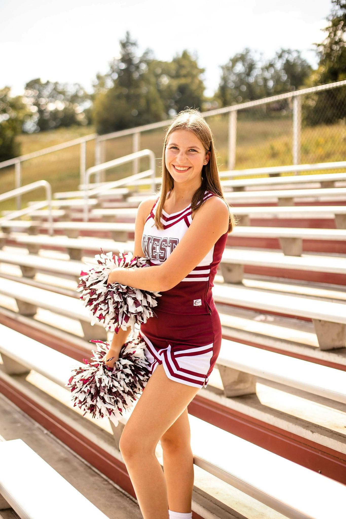 Studentessa partecipa al cheerleading sugli spalti di una scuola negli USA, vivendo sport, spirito di squadra e tradizioni del sistema scolastico americano.