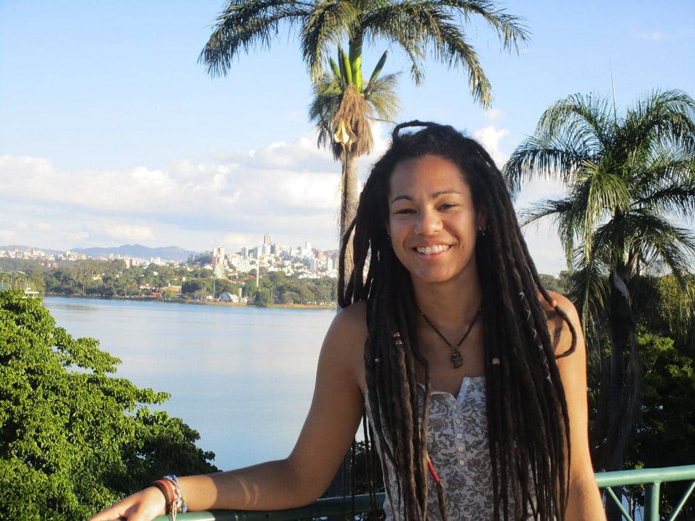 Student in Brazil with a view over lake and city, highlighting the balance between nature and urban life during a school exchange.
