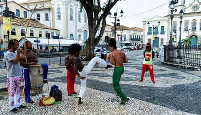 Capoeira in a historic Brazilian square with music and movement, showing living culture during a school exchange in Brazil.