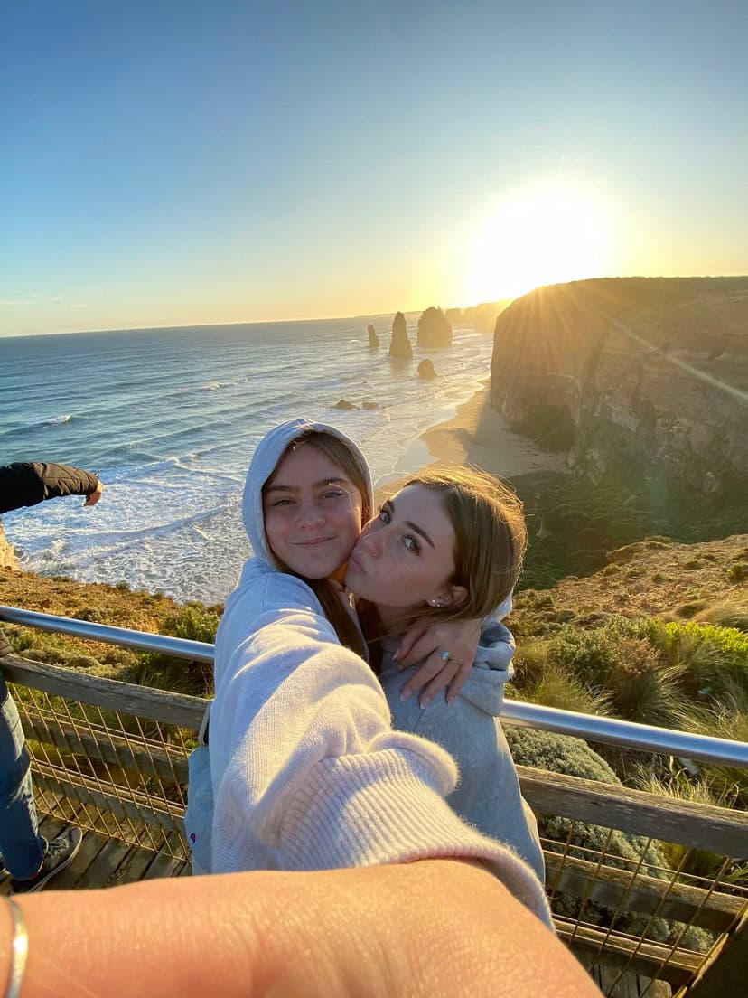 Students taking a selfie on the coast during a school programme in Australia, enjoying shared experiences.