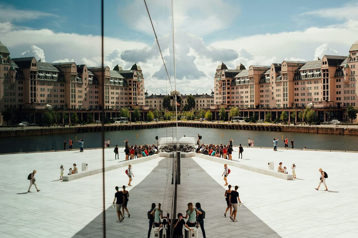 View of the square and river in Oslo, with reflections of modern Norwegian architecture, an immersive experience of urban culture during a school exchange year.
