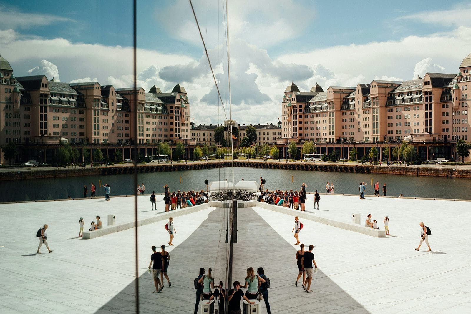 View of the square and river in Oslo, with reflections of modern Norwegian architecture, an immersive experience of urban culture during a school exchange year.