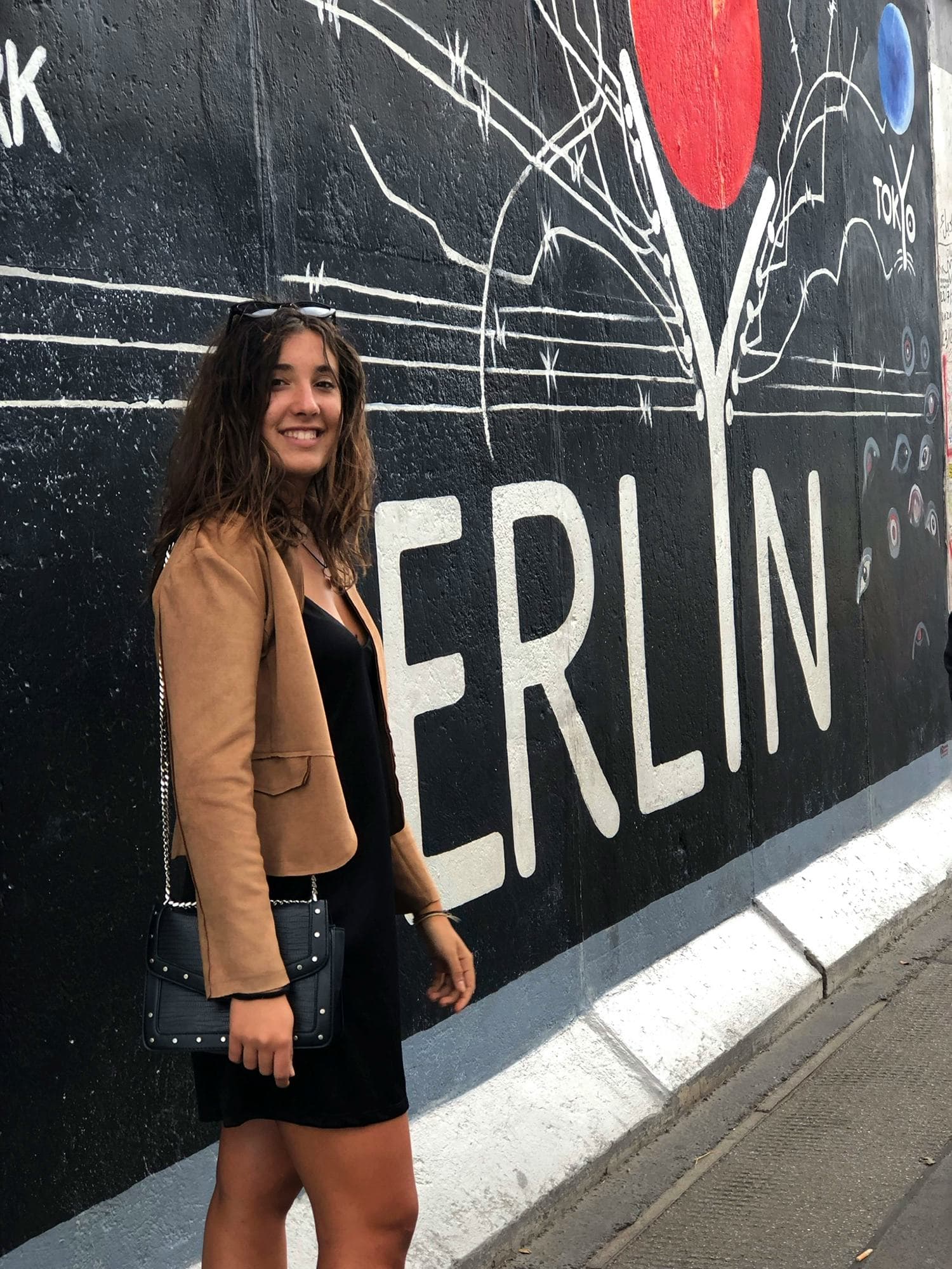 Student standing by a mural in Berlin during a school exchange programme in Germany, exploring urban culture and everyday life.