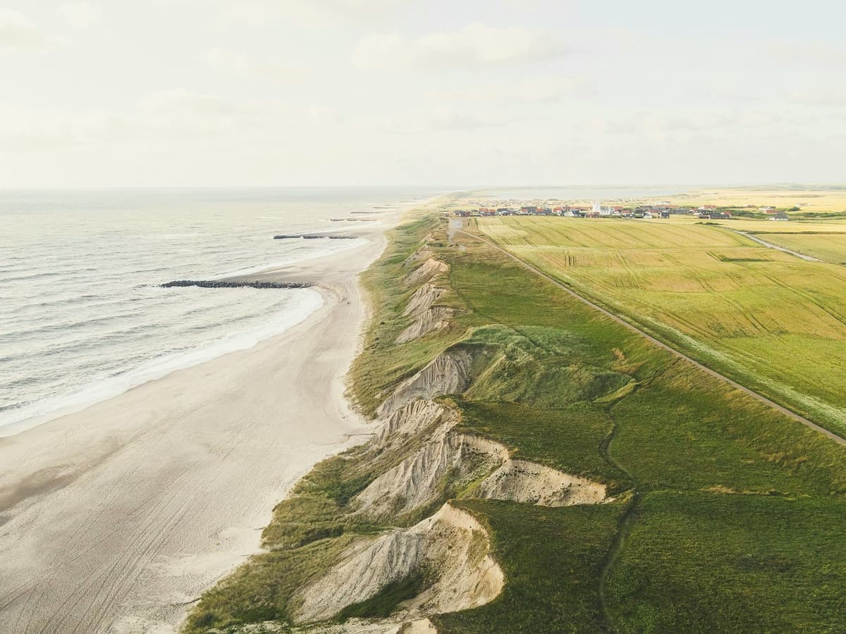 Aerial view of the Danish coastline with beach and dunes during a school exchange programme in Denmark, reflecting calm and balance.