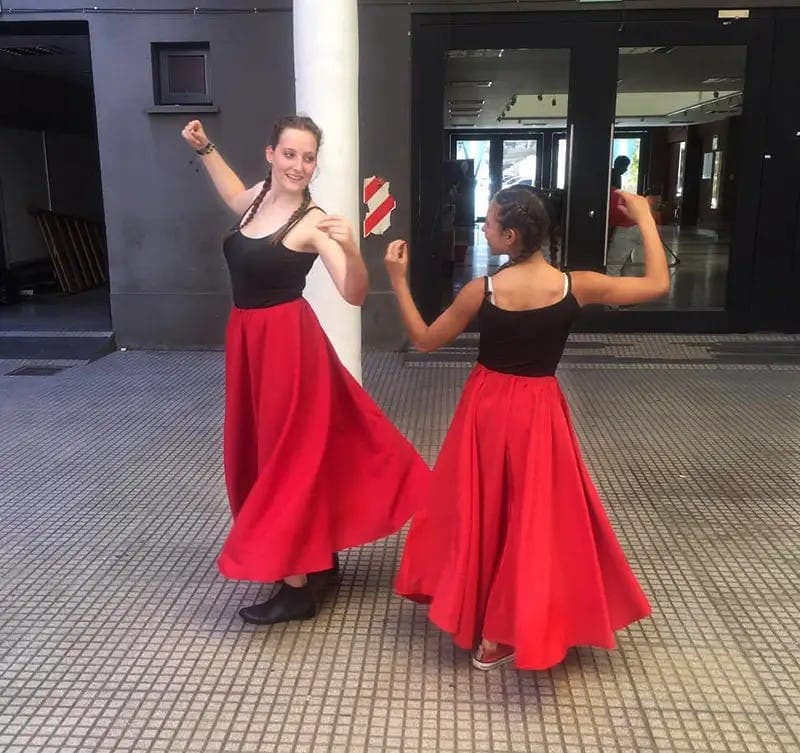 Students performing a traditional dance, representing cultural life during a school programme in Argentina.