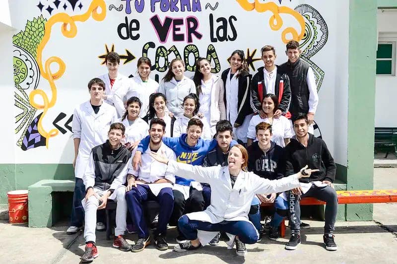 Group of students in front of a school mural, representing community and integration during a school programme in Argentina.