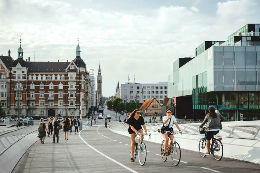 Students cycling in a Danish city during a school exchange programme in Denmark, combining local education with everyday urban life.