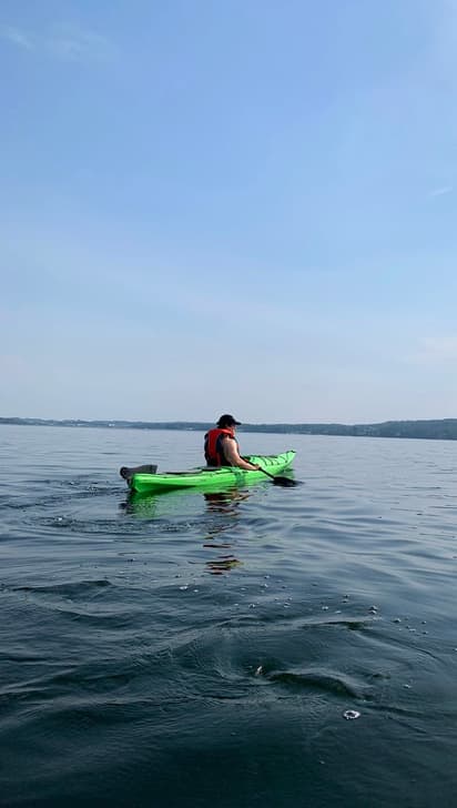 Student kayaking on a Canadian lake, showing outdoor activities and contact with nature during a study programme in Canada.