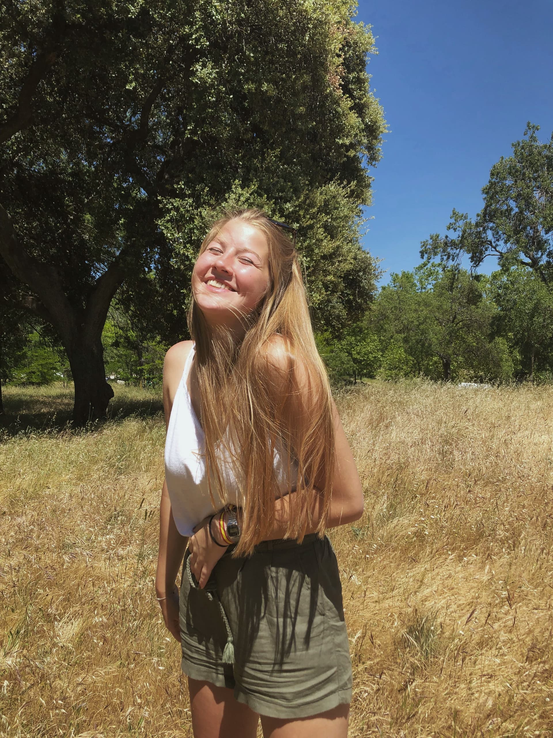 Image of a smiling girl in a natural landscape, a moment of joy and beauty during a study programme in Spain.