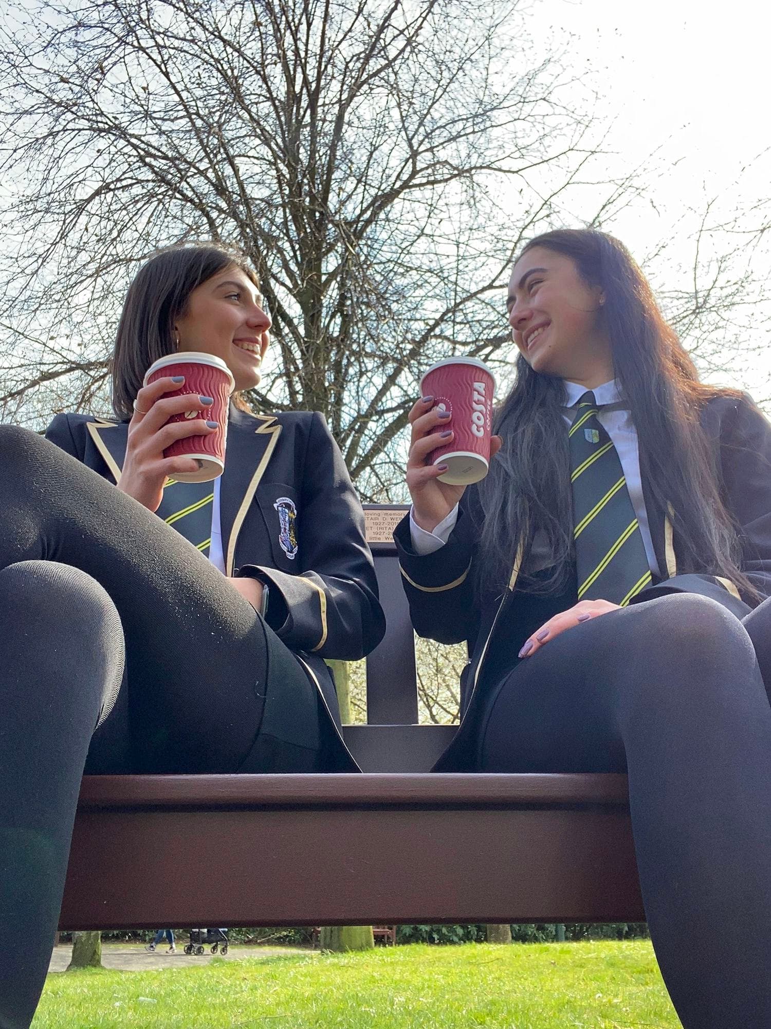 Two students in school uniform chatting outdoors, showing everyday student life during a school exchange programme in England.