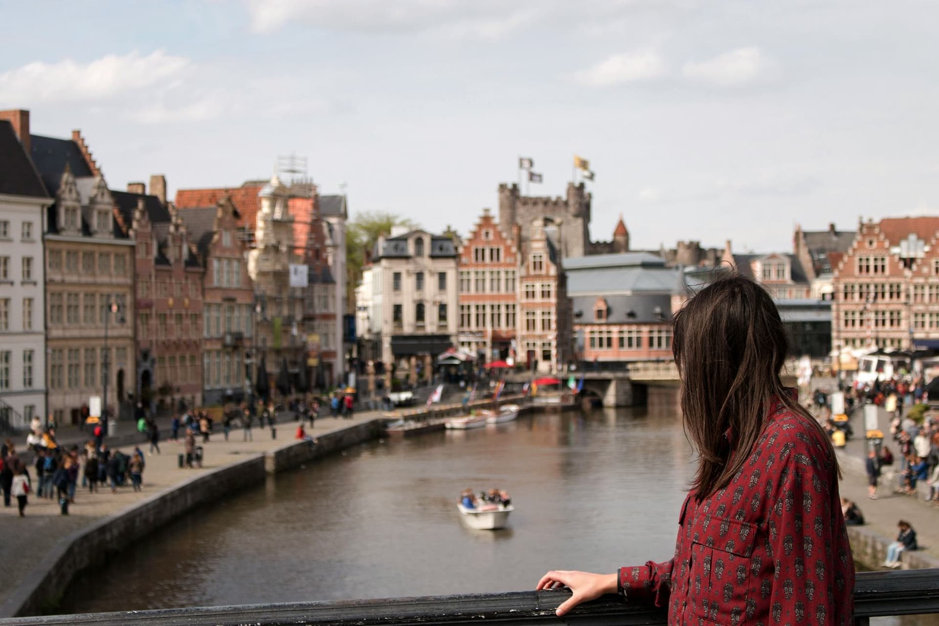 Student admiring the historic landscape of Ghent, a Belgian city rich in culture and history, during their study year abroad.